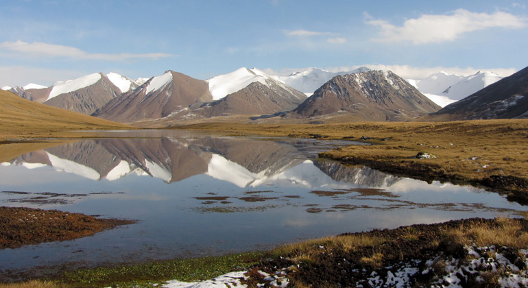 D. Farinotti, GFZ/WSL | Im See spiegeln sich die mit frischem Schnee bedeckten Gletscher von Teskey Ala-Too, Kirgisistan, wider. Der Eindruck täuscht: die Gletscher des Tien Shan verlieren dramatisch an Masse.