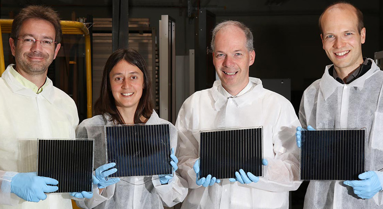 solaronix.com | R&D Team at Solaronix, holding Perovskite Solar Modules out of their prototype factory. (LtR: Frédéric Oswald, Stéphanie Narbey, Toby Meyer, and David Martineau.)