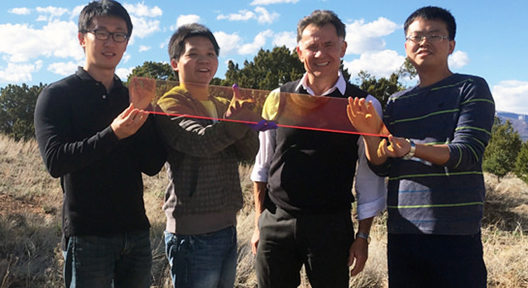 Los Alamos National Laboratory | Los Alamos Center for Advanced Solar Photophysics researchers hold a large prototype solar window. From left to right: Jaehoon Lim, Kaifeng Wu, Victor Klimov, Hongbo Li.