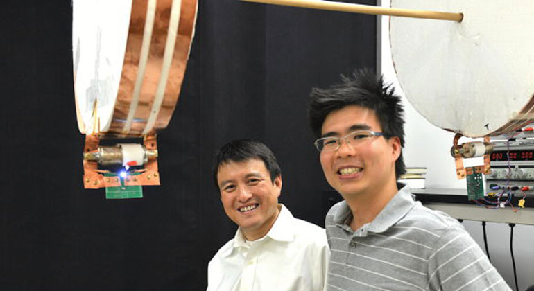 Mark Shwartz/Stanford University | Professor Shanhui Fan (left) and graduate student Sid Assawaworrarit have developed a device that can wirelessly charge a moving object at close range. The technology could be used to charge electric cars on the highway, or medical implants and cellphones as you walk nearby.