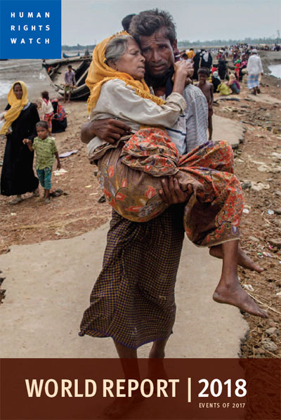 Human Rights Watch | 2017 Dar Yasin/AP | World Report 2018 | Abdul Kareem, a Rohingya Muslim, carries his mother, Alima Khatoon, to a refugee camp after crossing from Burma into Bangladesh on Sept. 16, 2017.