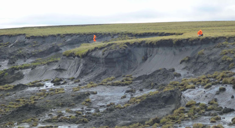 Guido Grosse, Alfred-Wegener-Institut | Ein massiver Tauwassereinbruch an der Yedoma-Küste der Bykowsky-Halbinsel wird von einem AWI-Permafrost-Team inspiziert.