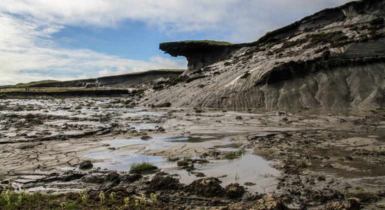 What dangers lie in industrial contaminated sites in permafrost?